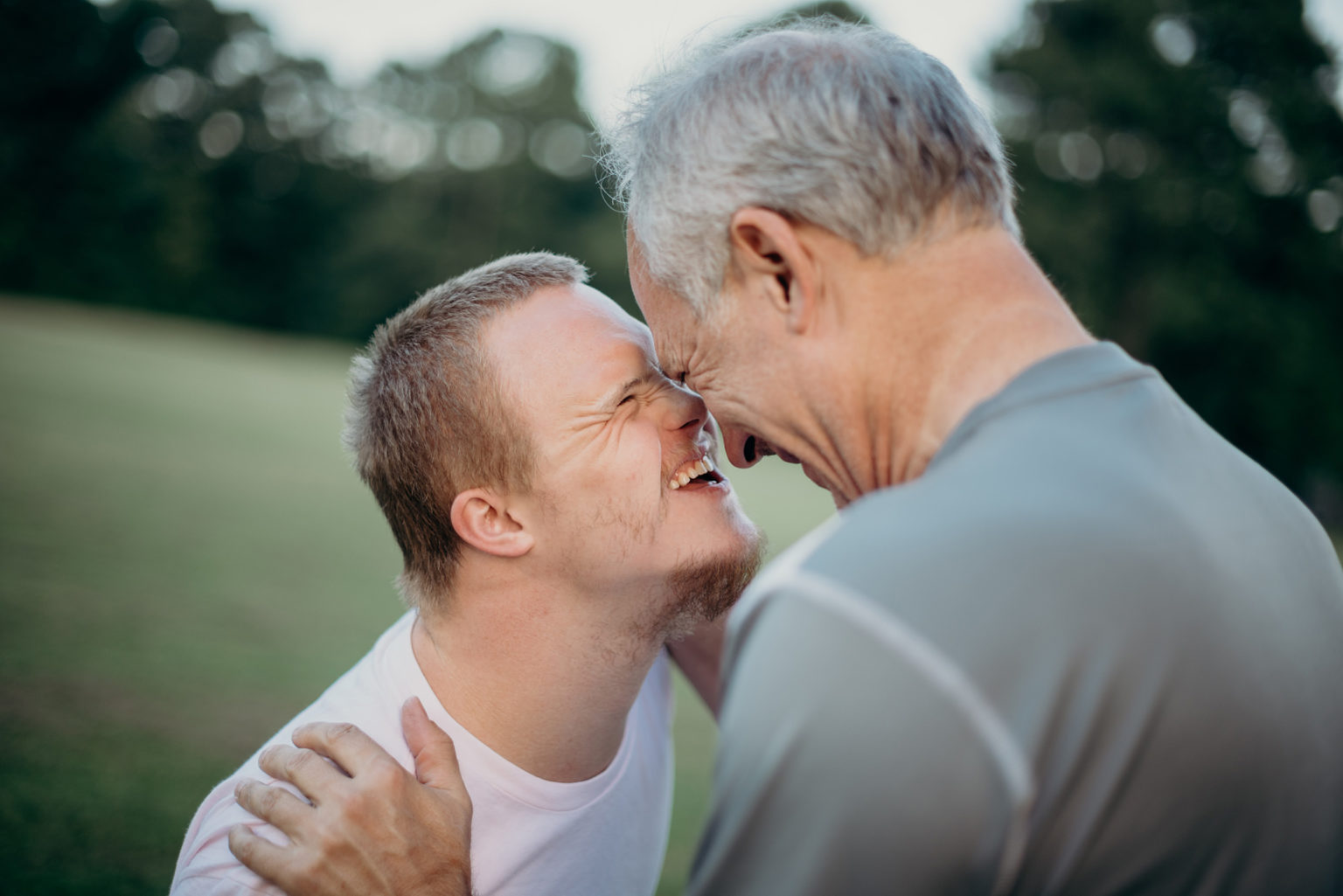 two men talking to each other on a grass field